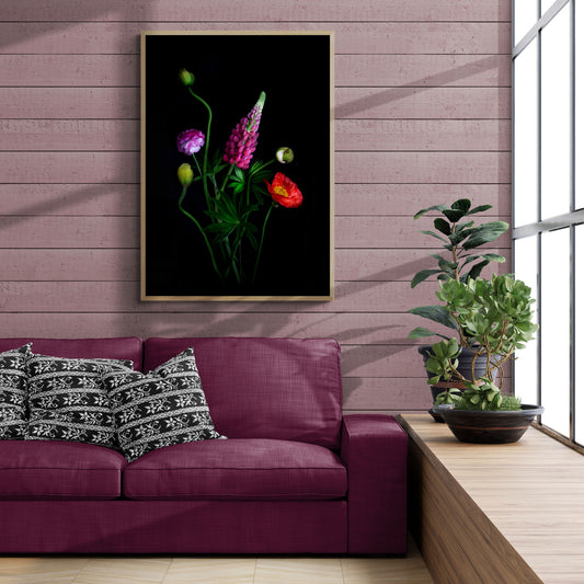 Living room with a purple sofa, decorative pillows, and a framed floral image on the wall featuring a Pink lupin and Ranuulus with a red Icelandic Poppy