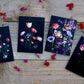 Botanical print greeting cards of tulips on a black background.