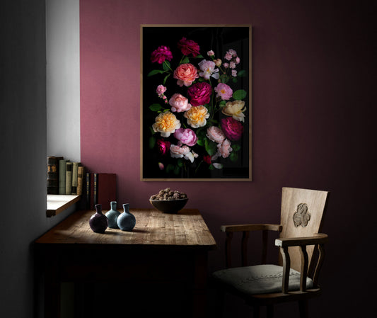 Framed dark botanical print of different coloured roses photographed on a black background hung on a plum coloured wall.