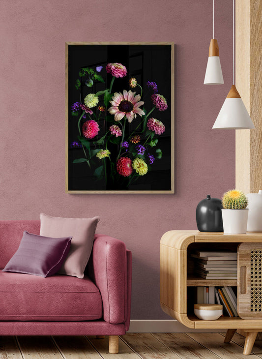 A botanical print featuring a Sunflower with Zinnias, Dahlias, Verbena and a touch of the Shoo Fly plant, Nicandra physalodes., framed on a peach coloured wall.