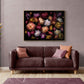 Landscape  format dark botanical print of multi-coloured heritage Chrysanthemums photographed on a black background hung above a sofa