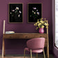 Purple wall with two framed floral artworks, featuring Helleborus 'Picotee', a wooden desk, and a pink chair.