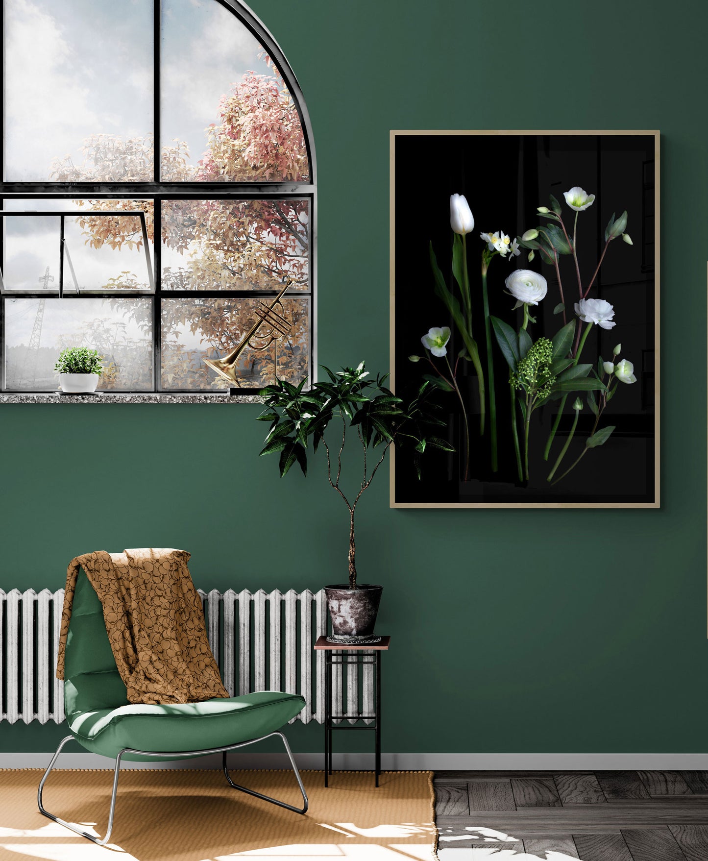 Framed dark botanical print of white Ranunculus , Narcissi, Hellebores and Skimmia photographed on a black background, hung on a green wall.