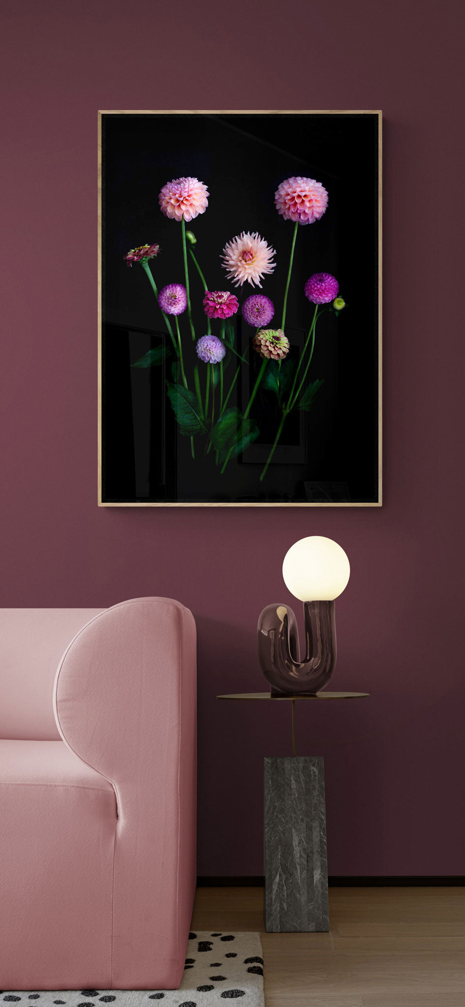 A dark botanical photograph of cool toned Dahlias and Zinnias on a black background., framed and hung os a plum coloured wall.