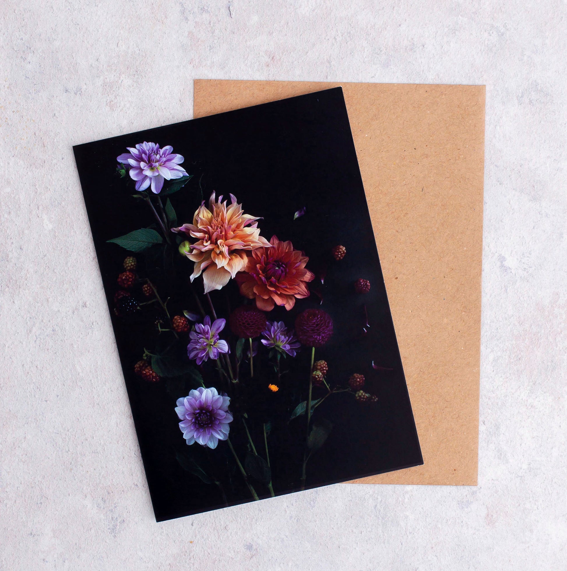 Botanical greeting card with mixed colour Dahlias and berries on a black background