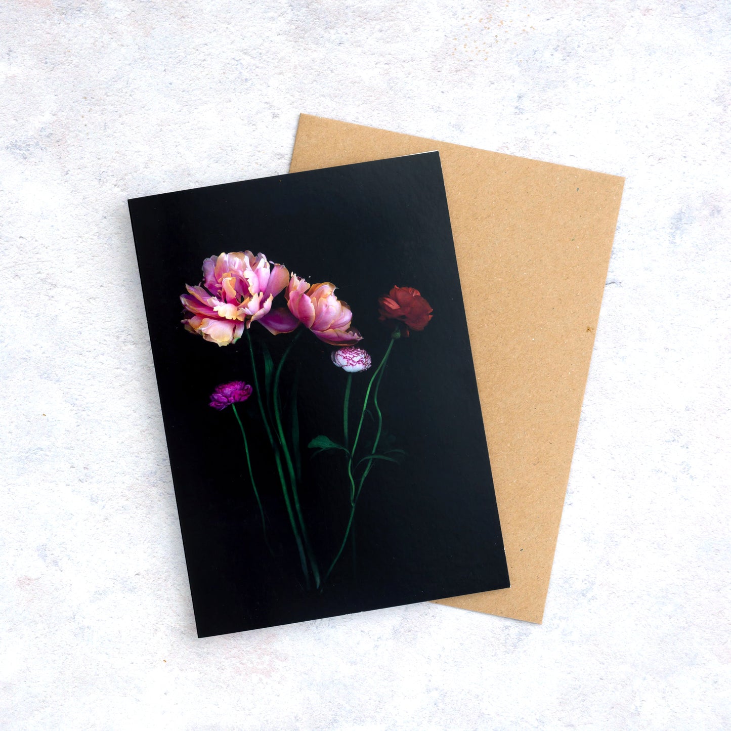 Botanical greeting card with Tulips and Ranunculus  photographed on a black background.