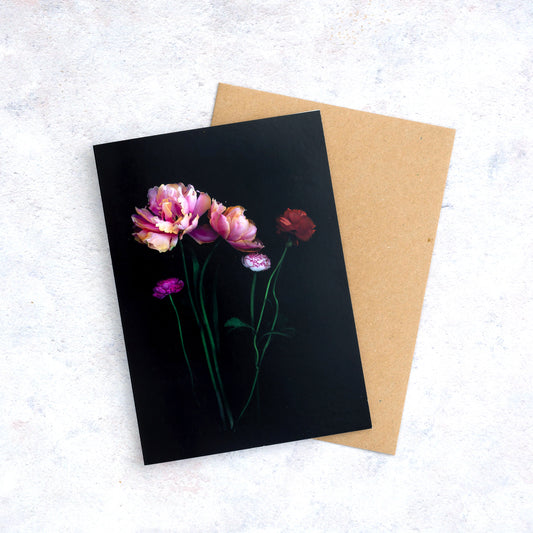 Botanical print greeting card with Tulips and Ranunculus  photographed on a black background.