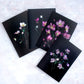 Four Botanical greeting cards featuring Hellebores photographed on a black background.