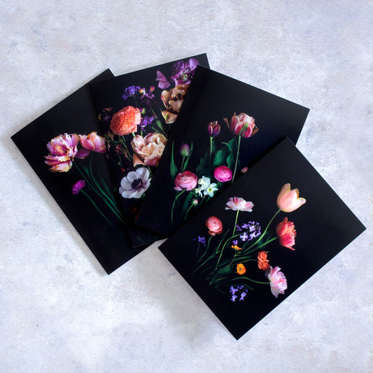 A collection of four botanical greeting cards featuring  Tulips photographed on a black background.