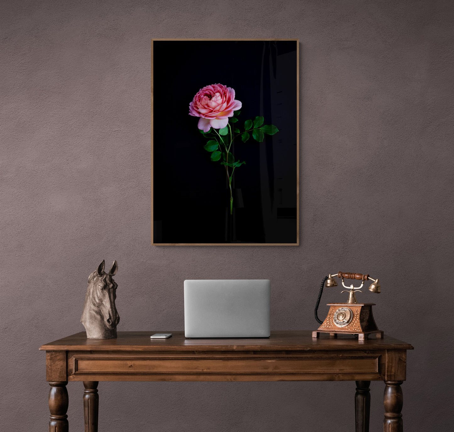 Dark botanical print, featuring a single, salmon -coloured Rose on a black background,, framed on a neutral wall.